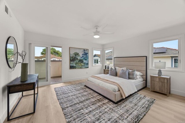 bedroom with access to exterior, light wood-type flooring, baseboards, and a ceiling fan