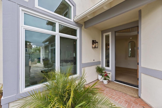 property entrance with stucco siding