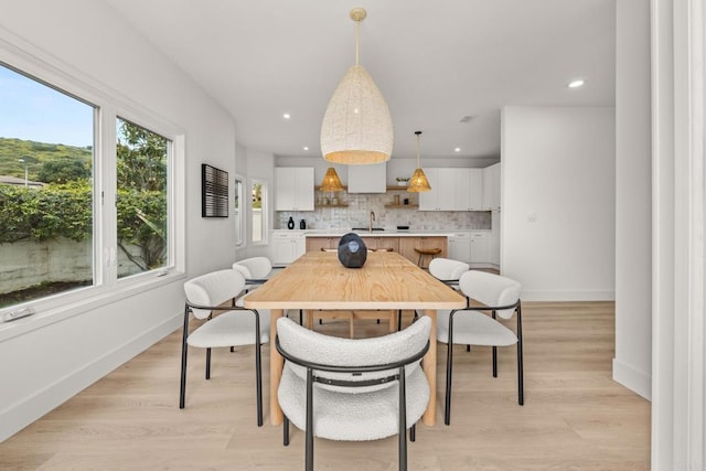 dining area with recessed lighting, baseboards, and light wood-type flooring