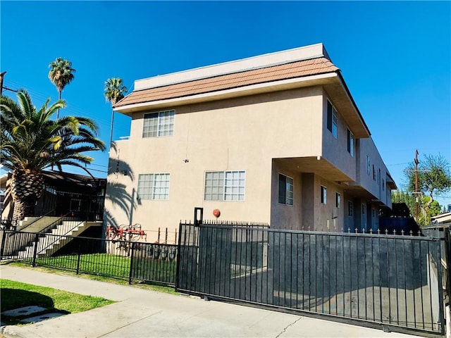 14253 Gilmore St Unit A, Van Nuys, CA 91401 - view of property exterior with a fenced front yard and stucco siding