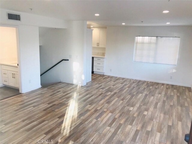 14253 Gilmore St Unit A, Van Nuys, CA 91401 - unfurnished living room featuring wood finished floors, recessed lighting, and baseboards
