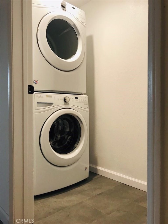 14253 Gilmore St Unit A, Van Nuys, CA 91401 - laundry area featuring estacked washer and dryer and baseboards