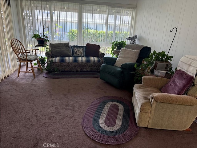 living room with carpet flooring and wooden walls