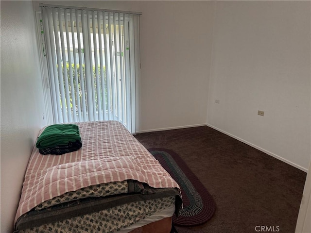 bedroom featuring carpet floors and baseboards
