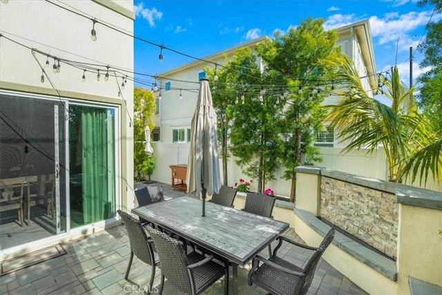 view of patio / terrace featuring fence and outdoor dining space