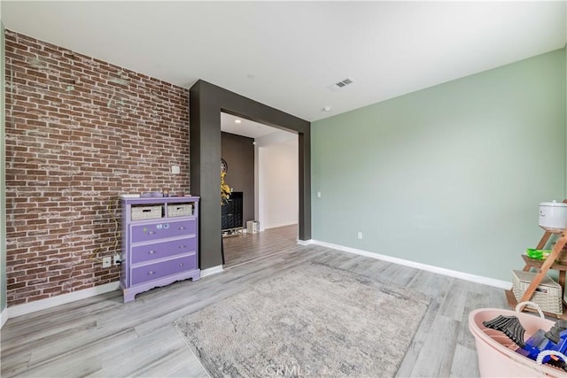 29652 Falcon Hill Dr, Menifee, CA 92584 - spare room featuring wood finished floors, baseboards, and brick wall