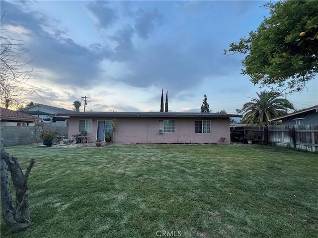 527 E King St, Rialto, CA 92376 - rear view of house with stucco siding and a patio