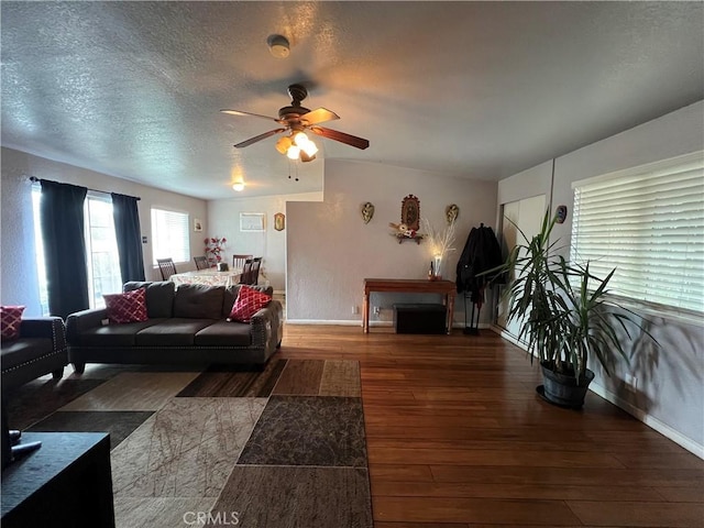 527 E King St, Rialto, CA 92376 - living room featuring baseboards, a ceiling fan, wood-type flooring, and a textured ceiling
