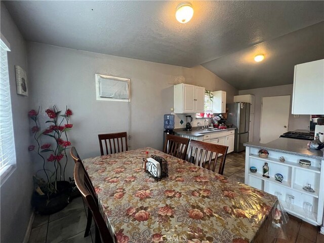 527 E King St, Rialto, CA 92376 - dining space with lofted ceiling and a textured ceiling