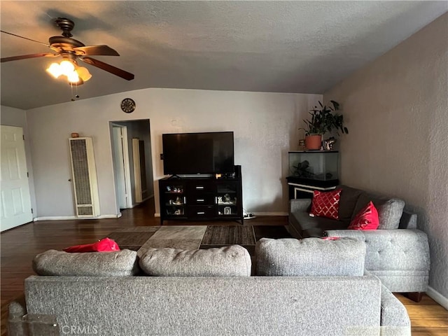 527 E King St, Rialto, CA 92376 - living room featuring a ceiling fan, wood finished floors, a heating unit, baseboards, and vaulted ceiling