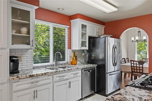 9 Benton Ave, Chico, CA 95973 - kitchen with a sink, appliances with stainless steel finishes, backsplash, and white cabinetry