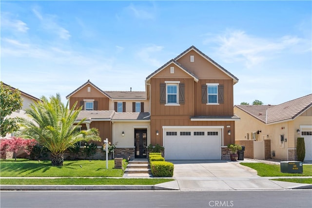6829 Birmingham Dr, Chino, CA 91710 - view of front of property featuring stone siding, driveway, a garage, and board and batten siding