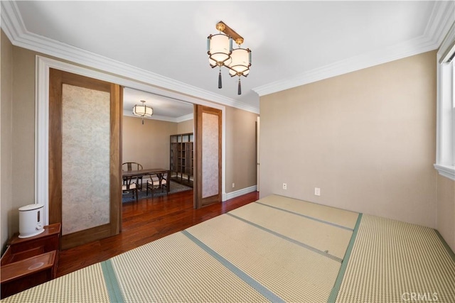 6829 Birmingham Dr, Chino, CA 91710 - empty room featuring wood finished floors, a chandelier, ornamental molding, and baseboards