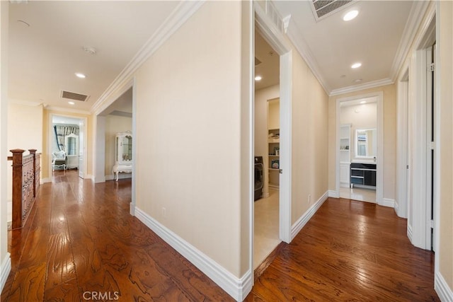 6829 Birmingham Dr, Chino, CA 91710 - hall with washer / dryer, wood finished floors, ornamental molding, recessed lighting, and baseboards