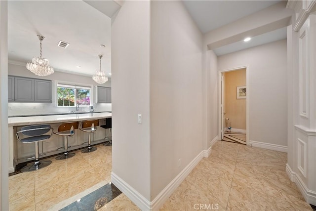 6829 Birmingham Dr, Chino, CA 91710 - hall with a chandelier, baseboards, a sink, and recessed lighting