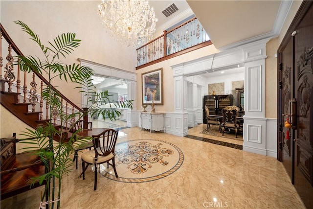 6829 Birmingham Dr, Chino, CA 91710 - building lobby with a decorative wall, ornamental molding, stairway, a wainscoted wall, and a towering ceiling