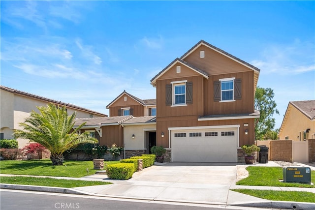 6829 Birmingham Dr, Chino, CA 91710 - view of front facade featuring an attached garage, concrete driveway, and stone siding