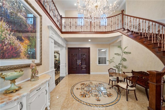 6829 Birmingham Dr, Chino, CA 91710 - foyer entrance with a towering ceiling, stairway, crown molding, a chandelier, and marble tiled flooring