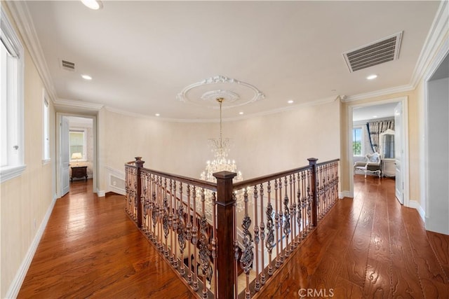 6829 Birmingham Dr, Chino, CA 91710 - corridor with wood finished floors, an upstairs landing, recessed lighting, ornamental molding, and a chandelier