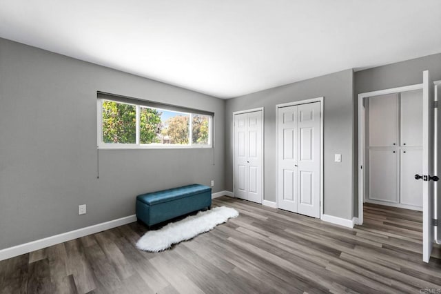 3221 Camarillo Ave, Oceanside, CA 92056 - unfurnished bedroom with multiple closets, wood finished floors, and baseboards