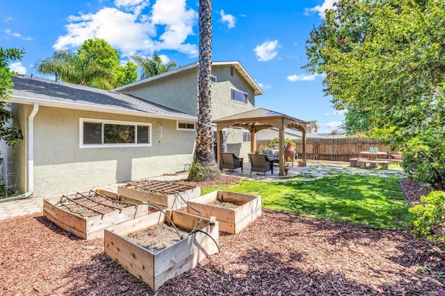3221 Camarillo Ave, Oceanside, CA 92056 - rear view of property with stucco siding, a vegetable garden, a gazebo, and a patio