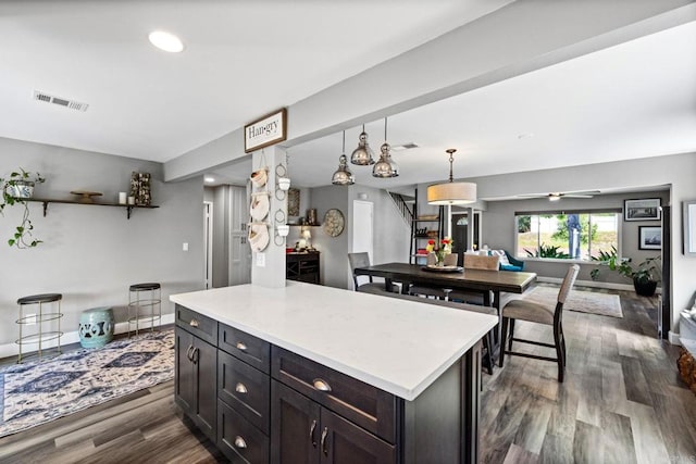3221 Camarillo Ave, Oceanside, CA 92056 - kitchen with dark wood-style floors, light countertops, hanging light fixtures, recessed lighting, and baseboards