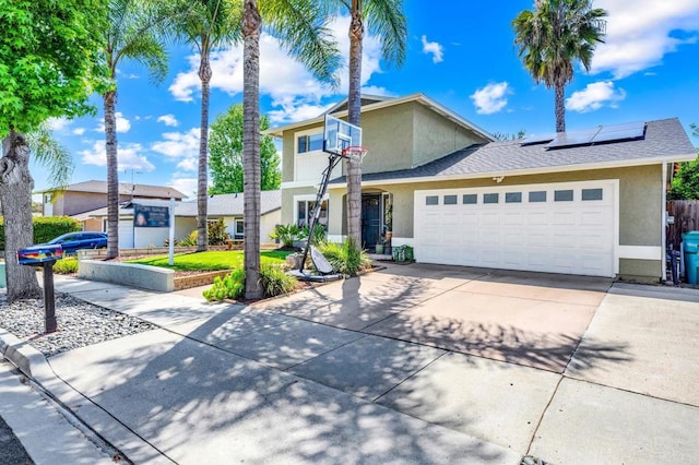 3221 Camarillo Ave, Oceanside, CA 92056 - traditional-style house featuring stucco siding, a garage, concrete driveway, and solar panels