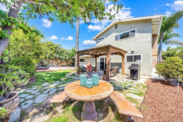 3221 Camarillo Ave, Oceanside, CA 92056 - back of house featuring a gazebo, stucco siding, a patio area, and fence