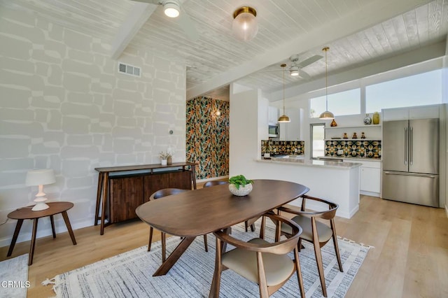 dining area featuring beam ceiling, wooden ceiling, a ceiling fan, and light wood-style floors