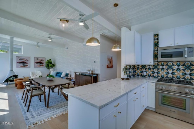 kitchen with stainless steel appliances, a ceiling fan, light wood finished floors, light stone counters, and backsplash