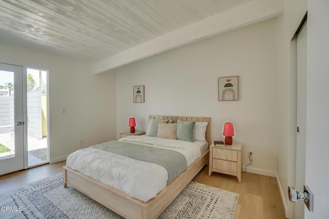 2839 N Davis Way, Palm Springs, CA 92262 - bedroom with access to outside, light wood-style floors, and beamed ceiling