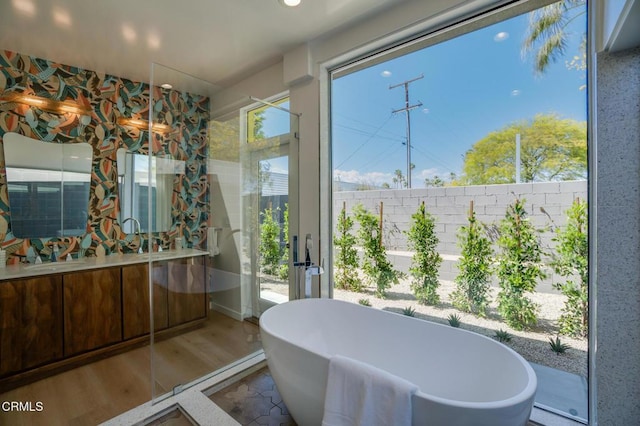 2839 N Davis Way, Palm Springs, CA 92262 - bathroom featuring a freestanding tub, wood finished floors, and vanity
