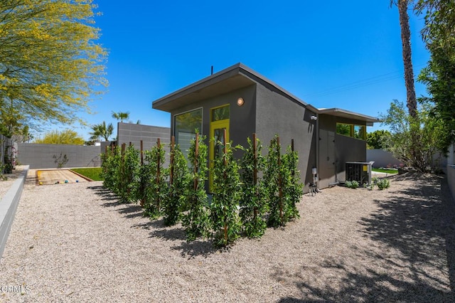 2839 N Davis Way, Palm Springs, CA 92262 - view of side of home with stucco siding and a central AC unit