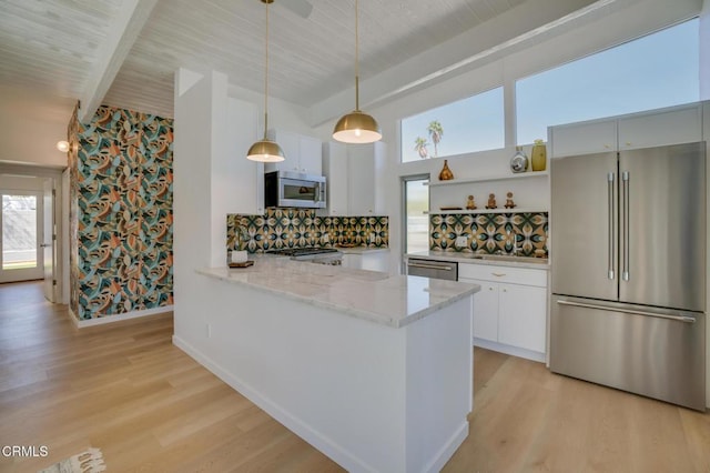 2839 N Davis Way, Palm Springs, CA 92262 - kitchen featuring stainless steel appliances, light wood finished floors, backsplash, light stone countertops, and decorative light fixtures