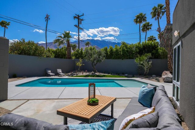 2839 N Davis Way, Palm Springs, CA 92262 - view of swimming pool featuring outdoor lounge area, a fenced backyard, a mountain view, and a patio