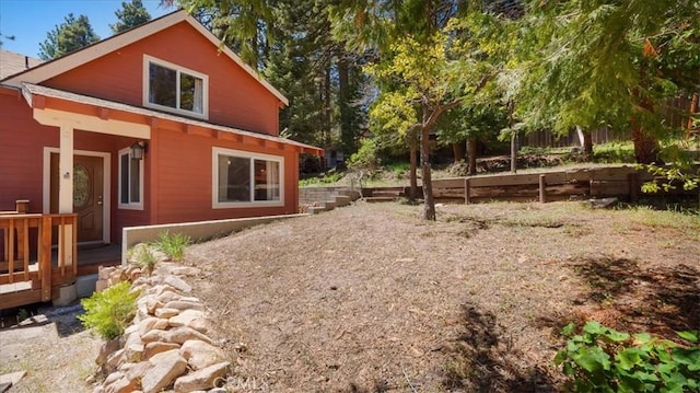 view of side of property featuring fence