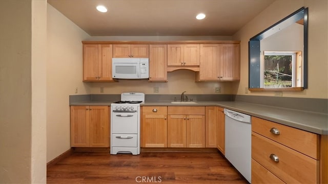 kitchen featuring white appliances, a sink, dark wood-type flooring, light brown cabinets, and recessed lighting