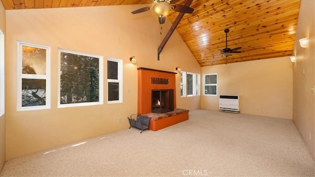 unfurnished living room with ceiling fan, wood ceiling, carpet flooring, heating unit, and high vaulted ceiling