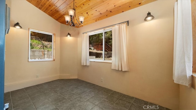 empty room featuring wooden ceiling, a chandelier, and dark tile patterned flooring