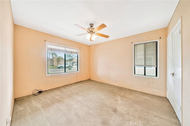 spare room with carpet floors and ceiling fan
