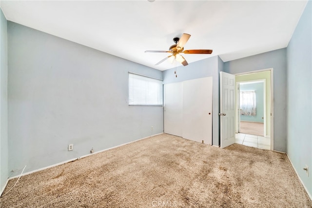 unfurnished bedroom with carpet, ceiling fan, and baseboards