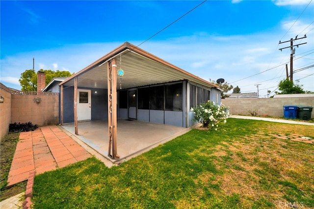 rear view of property featuring a patio area and a sunroom