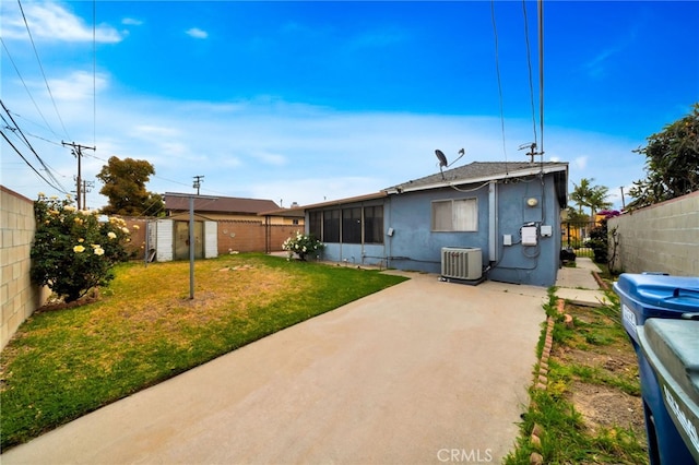 rear view of property with central air condition unit, a storage unit, a patio, an outdoor structure, and stucco siding