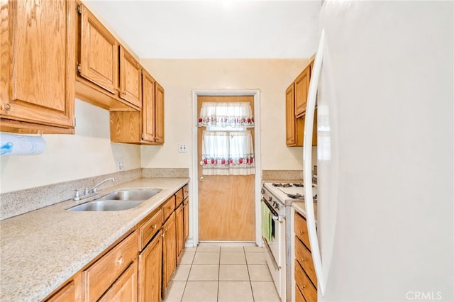 kitchen featuring white appliances, a sink, light countertops, and light tile patterned floors