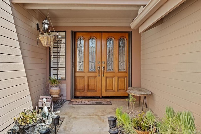view of exterior entry featuring covered porch