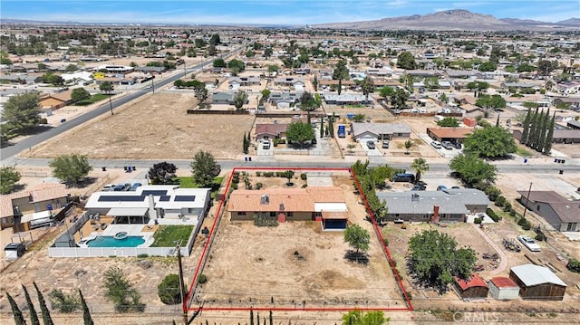 aerial view of residential area featuring property boundaries highlighted, a pool area, and mountains