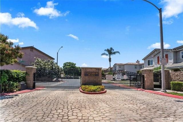 3818 Coastal St, Riverside, CA 92501 - view of road with a gate, curbs, street lights, a gated entry, and a residential view