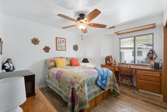 1995 E Valley Forge Ave, Tulare, CA 93274 - bedroom with wood finished floors, ceiling fan, and a desk