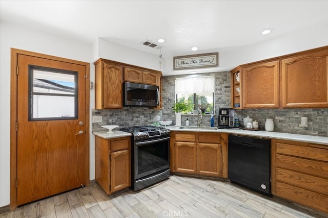 1995 E Valley Forge Ave, Tulare, CA 93274 - kitchen with appliances with stainless steel finishes, a sink, brown cabinets, light countertops, and recessed lighting