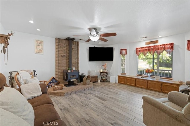 1995 E Valley Forge Ave, Tulare, CA 93274 - living room with a wood stove, light wood finished floors, a ceiling fan, and recessed lighting